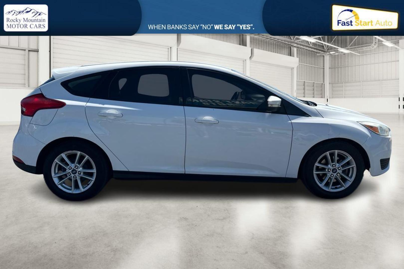2015 White Ford Focus SE Hatch (1FADP3K23FL) with an 2.0L L4 DOHC 16V engine, 5-Speed Manual transmission, located at 7755 State Street, Midvale, UT, 84047, (801) 753-9063, 40.610329, -111.890656 - Photo#1