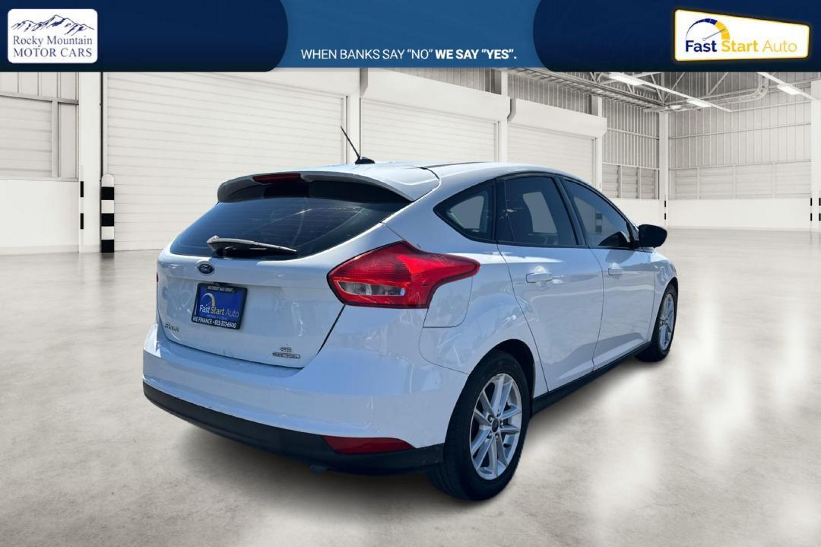 2015 White Ford Focus SE Hatch (1FADP3K23FL) with an 2.0L L4 DOHC 16V engine, 5-Speed Manual transmission, located at 7755 State Street, Midvale, UT, 84047, (801) 753-9063, 40.610329, -111.890656 - Photo#2