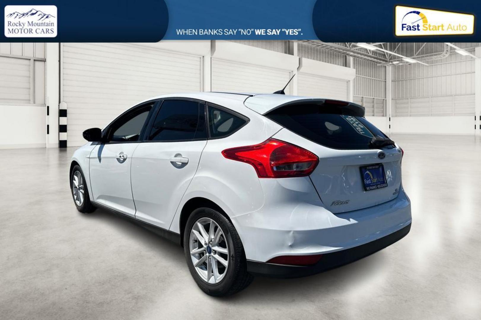 2015 White Ford Focus SE Hatch (1FADP3K23FL) with an 2.0L L4 DOHC 16V engine, 5-Speed Manual transmission, located at 7755 State Street, Midvale, UT, 84047, (801) 753-9063, 40.610329, -111.890656 - Photo#4