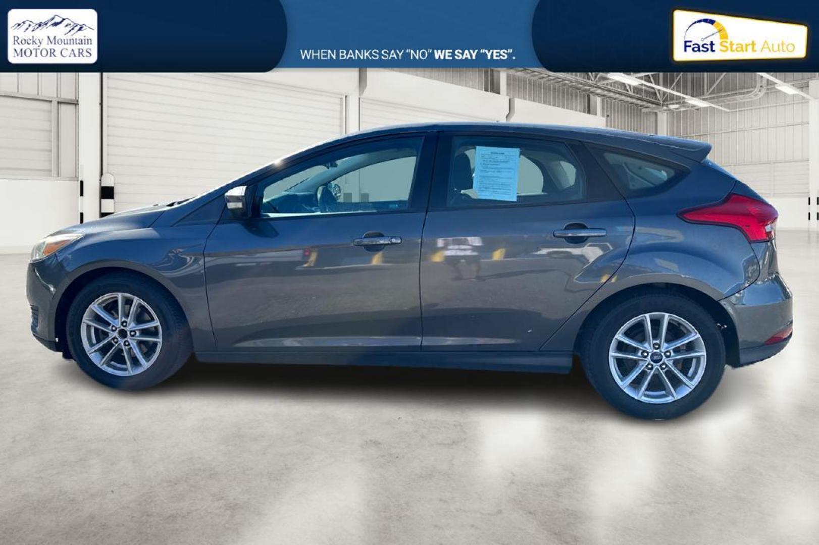 2015 Gray Ford Focus SE Hatch (1FADP3K22FL) with an 2.0L L4 DOHC 16V engine, 5-Speed Manual transmission, located at 7755 State Street, Midvale, UT, 84047, (801) 753-9063, 40.610329, -111.890656 - Photo#5